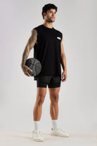 Model wearing the black Training Dept tank top with a basketball, showing the oversized fit